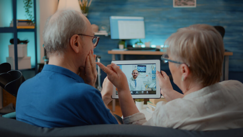 Senior woman talking to a humanoid robotic companion in a care home
