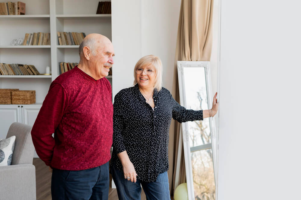 A happy senior couple enjoying time together in a cozy living room.