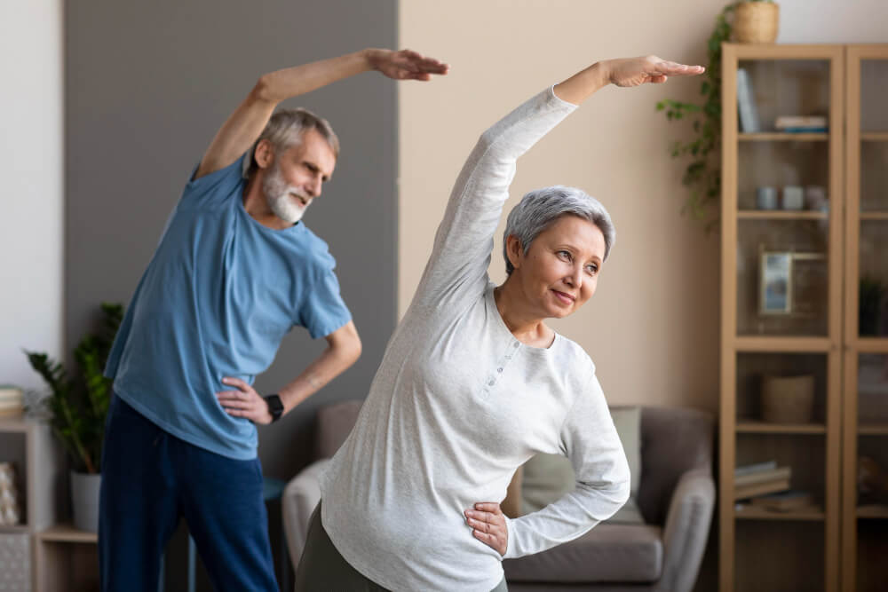 Senior couple stretching and exercising together at home.